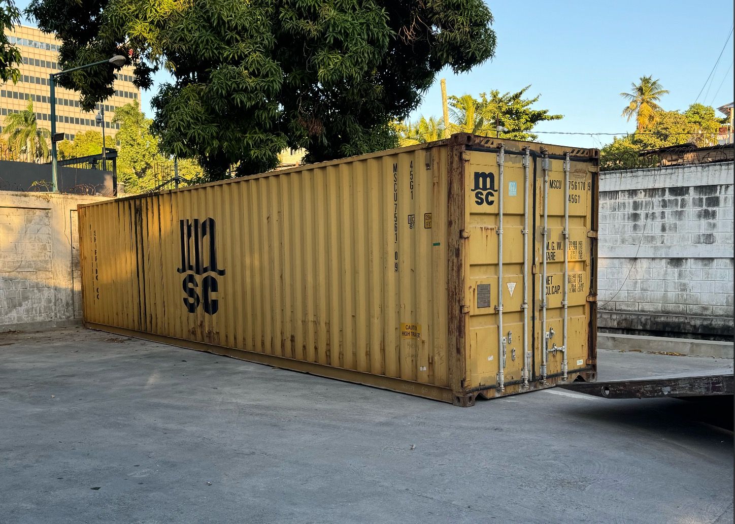 Shipping container loaded on a flatbed truck for transport